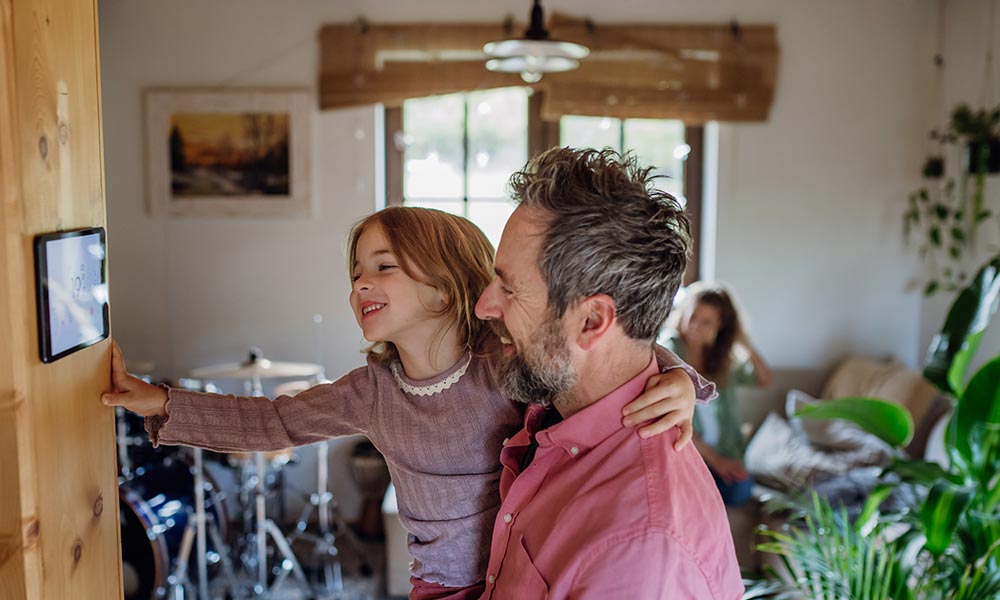 dad with girl looking at home heating system