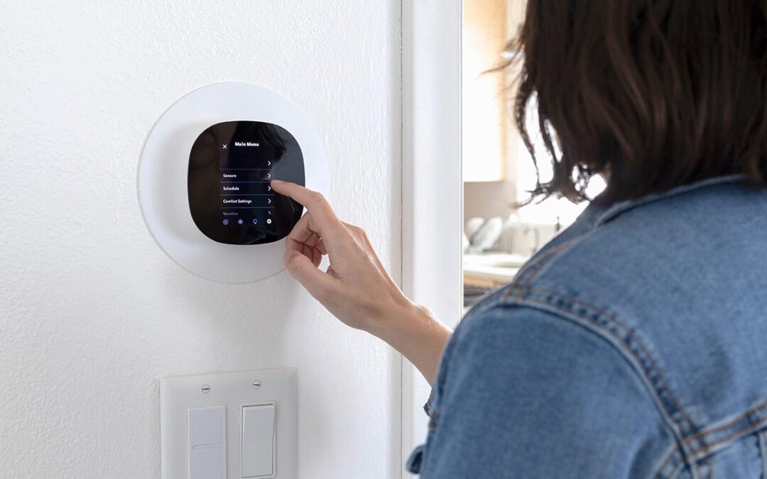 woman touching a carrier smart thermostat